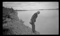 H. H. West spitting into the Yukon River, Circle, 1946