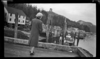 Mertie West looks out from a dock in Chatham, Sitka, 1946