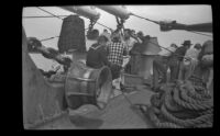 Steerage passengers stand on the bow of the ship, Alaska en route, 1946
