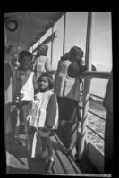 Native American children wear life preservers during a ship safety drill, Alaska en route, 1946