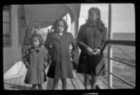 Three Native American girls pose on a promenade deck, Seattle vicinity, 1946