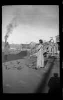 Local woman feeding pigeons in the street, Valdez, 1946