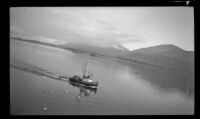 Fishing boat sailing through a channel, Juneau vicinity, 1946