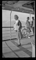 Mertie West wears a life preserver on a ship's deck, Juneau vicinity, 1946