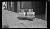Two butane tanks sit outside the H. H. West Company offices on Omar Avenue, Los Angeles, 1946