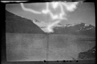 View looking across Passage Canal towards snow-covered mountains, Whittier, 1946