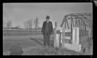 Frank Iddings poses in front of a bridge crossing the East Nishnabotna River, Red Oak, 1946