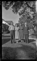 Hebard West, Ann West, Maud West and Wayne West pose on the front lawn of Wayne West's residence, Santa Ana, 1946