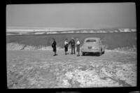 Dode Witherby, Zetta Witherby, West Witherby and Mertie West stand beside their car en route to Death Valley, Death Valley National Park vicinity, 1947