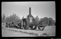Old steam tractor and ore wagons, viewed at an angle, Death Valley National Park, 1947