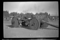 Wagon with heavy stone wheels sits on display near Furnace Creek Camp, Death Valley National Park, 1947