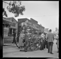 Nita Tribe and D. L. Tribe pose in front of a wagon at Knott's Berry Farm, Buena Park, 1947