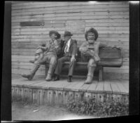 H. H. West sits on a bench with "Handsome Brady" and "Whiskey Bill" at Knott's Berry Farm, Buena Park, 1947