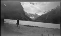 Mertie West stands near the edge of Lake Louise and looks across the lake, Lake Louise, 1947