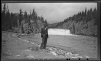 H. H. West poses in front of Bow Falls, Banff, 1947