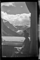 Mertie West sits by a window overlooking Lake Louise at Chateau Lake Louise, Lake Louise, 1947