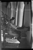Mertie West sits at a writing desk in the lobby of Chateau Lake Louise, Lake Louise, 1947