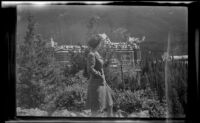 Girl from Toronto stands at a viewpoint overlooking the Banff Springs Hotel, Banff, 1947