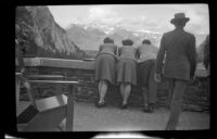 Two women and a man look over a parapet at the Banff Springs Hotel, Banff, 1947