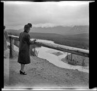 Mertie West looks across the southwestern Alberta landscape from a scenic overlook, Alberta, 1947