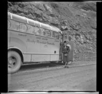 Mertie West poses beside the touring bus while traveling between Jasper and Lake Louise, Alberta, 1947