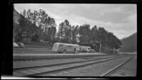 West's touring bus parked at a railroad station, Field, 1947