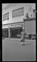 Mertie West walks towards Pike Place Market, Seattle, 1947