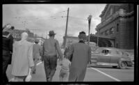Mertie West and others cross 4th Avenue near Union Station, Seattle, 1947