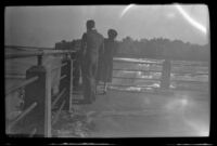 Mertie West and Mr. Stewart look over the rail at the American Falls, Niagara Falls, 1947