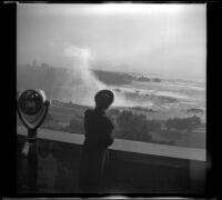 Mertie West looks over a parapet towards Horseshoe (or Canadian) Falls, Niagara Falls, 1947