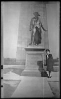 Mertie West poses beside a statue of Colonel William Prescott at Bunker Hill Monument, Boston, 1947