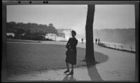 Unknown woman walking past the camera at an observation point overlooking the American Falls, Niagara Falls, 1947