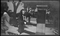 Mertie West poses beside the Fox Hill Plaque at an entrance to Boston Common, Boston, 1947
