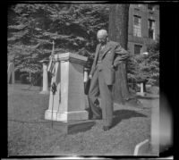 H. H. West stands beside Paul Revere's grave marker in the Granary Burying Grounds, Boston, 1947