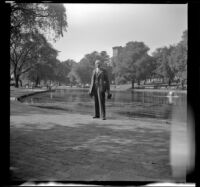 H. H. West poses in front of the Boston Common Frog Pond, Boston, 1947