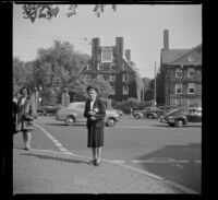 Mertie West stands on a street corner outside Harvard University, Cambridge, 1947