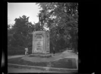 Mertie West poses beside the "Minute Man" memorial at Old North Bridge, Concord, 1947