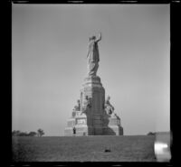Mertie West poses at the base of the National Monument to the Forefathers, Plymouth, 1947