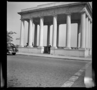 Mertie West stands under the portico covering Plymouth Rock, Plymouth, 1947