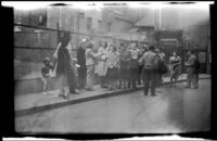 Crowd gathers on a sidewalk in Chinatown, New York, 1947