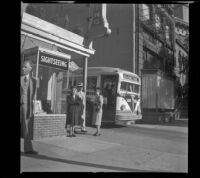 Mertie West next to a Gettysburg sight seeing bus, Washington, D.C., 1947