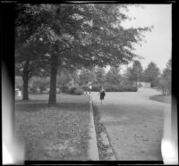 Mertie West walks along a driveway in Arlington National Cemetery, Arlington, 1947