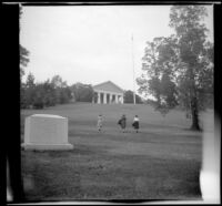 Mertie West and 2 unidentified women walk up the lawn slope to Lee Mansion, Arlington, 1947