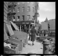 Mertie West walks past a construction site and towards Richmond Street, [Boston], 1947