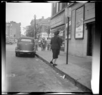 Mertie West steps onto a curb while walking through Alexandria, Alexandria, 1947