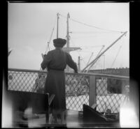 Mertie West looks down onto the S. S. Del Norte from behind a guardrail on the S. S. President, New Orleans, 1947