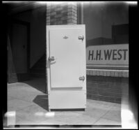 Woodlin electric refrigerator stands on a sidewalk, Los Angeles, 1948