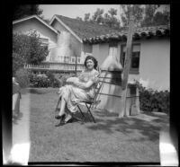 Alice Shaw sits in the backyard of the McDonald residence during a picnic, Burbank, 1948