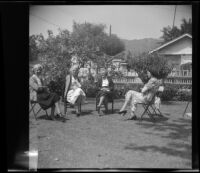 Mertie West, Josie Shaw, Hannah Lockwood and Alice Shaw sit around the McDonalds' backyard during a picnic, Burbank, 1948