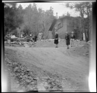 Agnes Whitaker, Mertie West and Forrest Whitaker pose on the driveway leading up to the Siemsen's cabin near Gray's Camp, Big Bear Lake, 1948